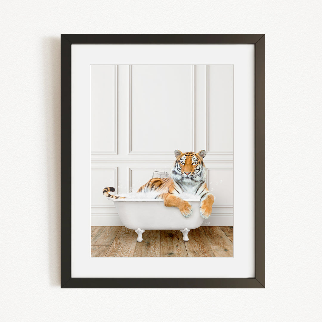 A tiger is sitting in a white bathtub, appearing relaxed and enjoying the bath.