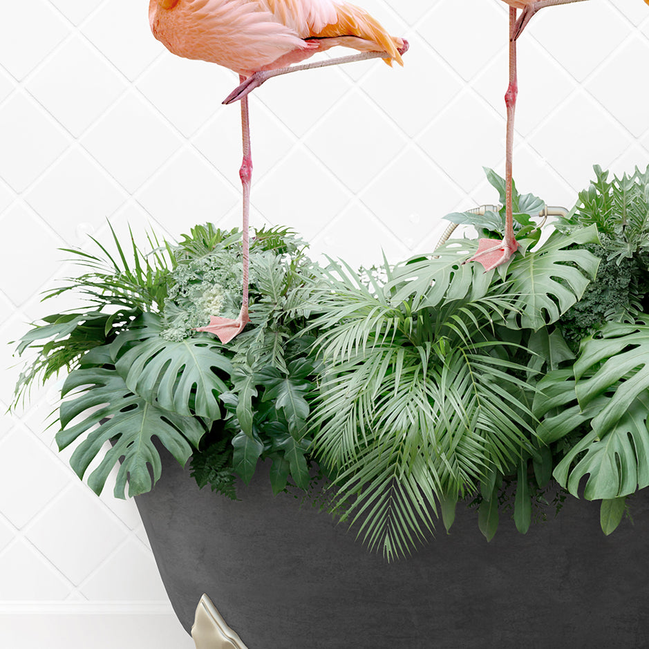 two flamingos standing on top of a plant pot