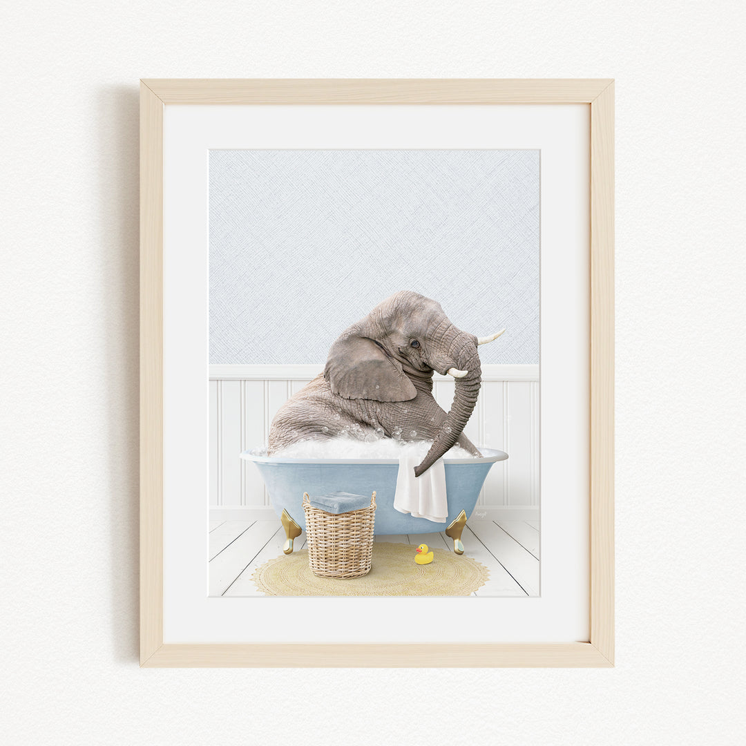 A gray elephant sitting in a blue bathtub filled with water, surrounded by a yellow rubber duck and a basket.