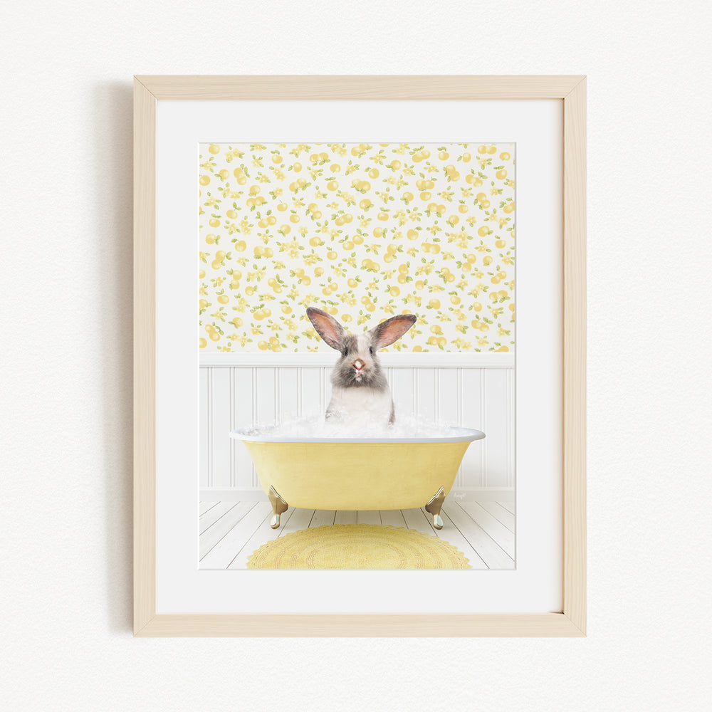 A cute rabbit sitting in a yellow bathtub filled with bubbles, surrounded by a yellow floral wallpaper.