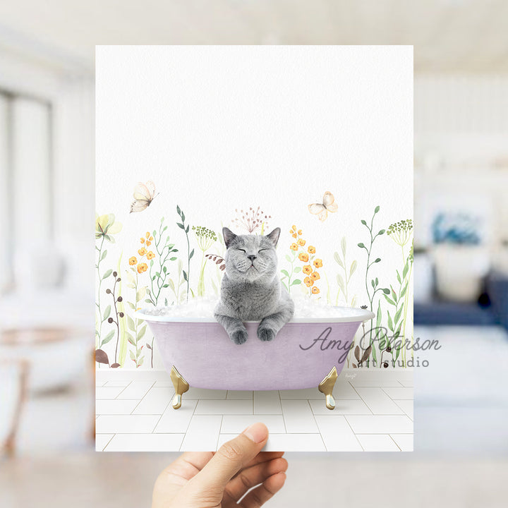 a person holding up a card with a cat in a bathtub