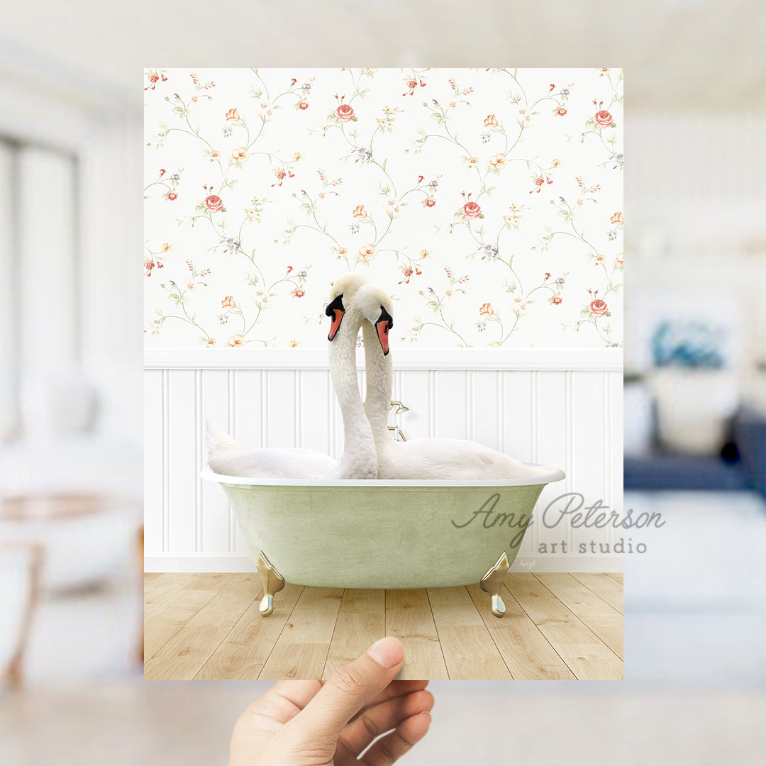 a person holding up a picture of a swan in a bathtub