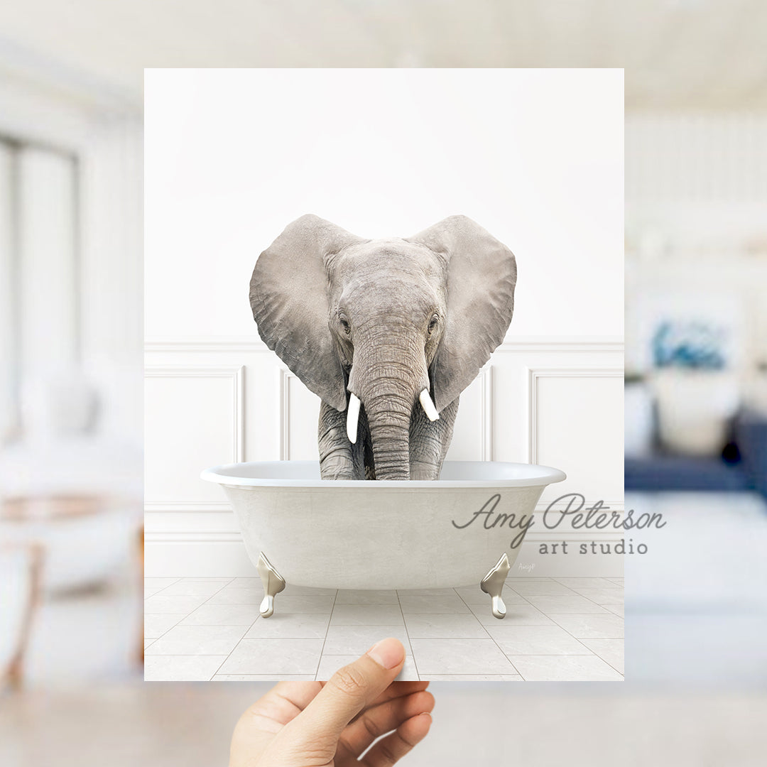 a hand holding a card with an elephant in a bathtub