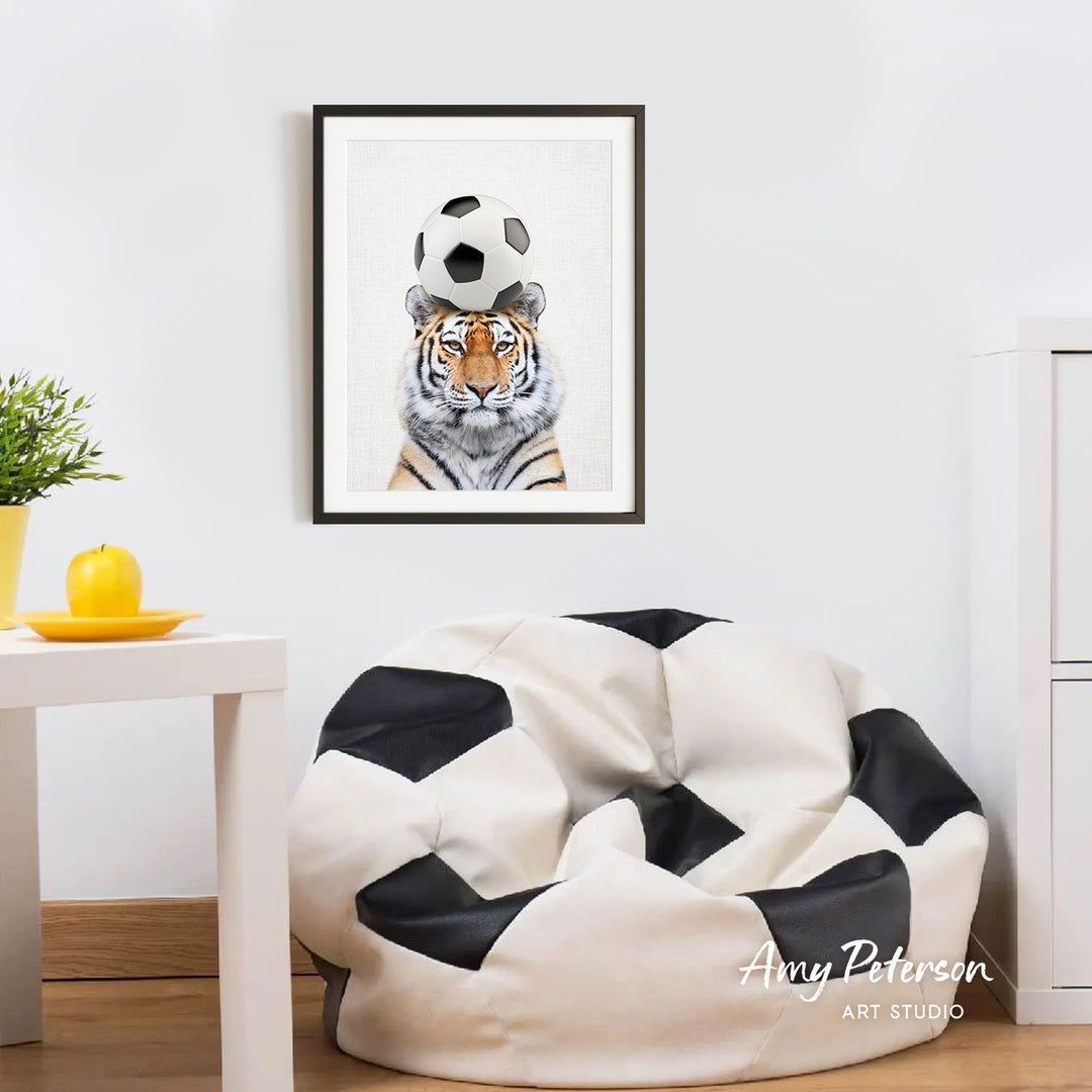a tiger with a soccer ball on its head, which is a playful and creative depiction of the animal engaging in a sport.