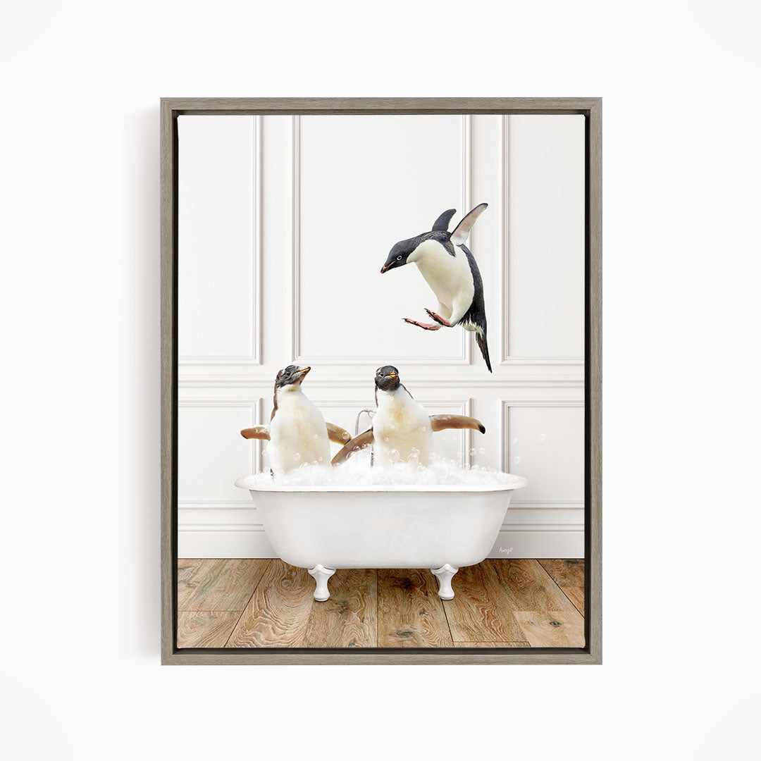 A framed image depicting three penguins sitting in a white bathtub, with one penguin flying towards the tub.