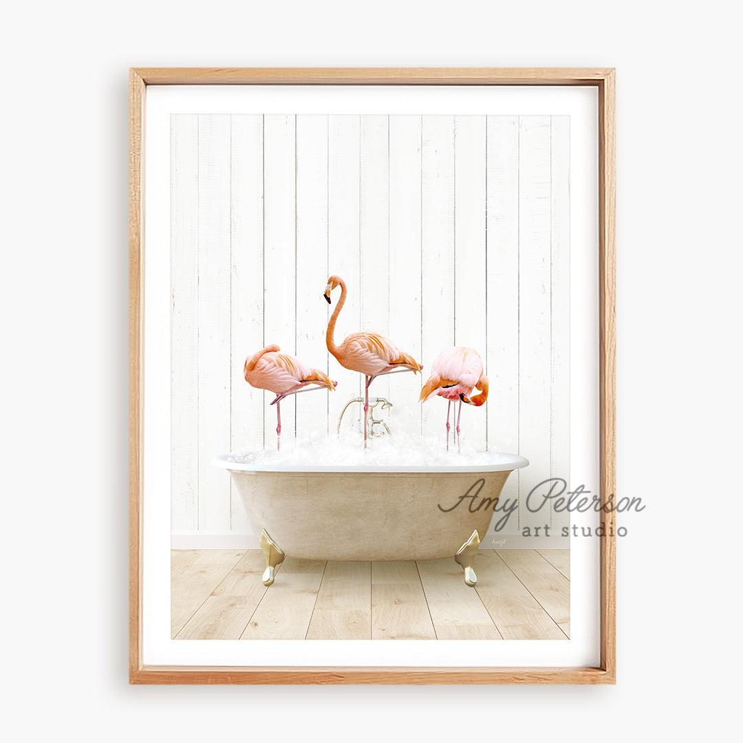 three flamingos in a bathtub with water in it