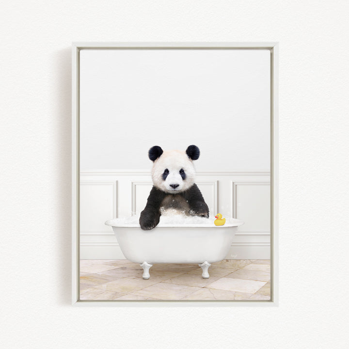 A panda bear sitting in a white bathtub, surrounded by a white wall and a yellow rubber duck.