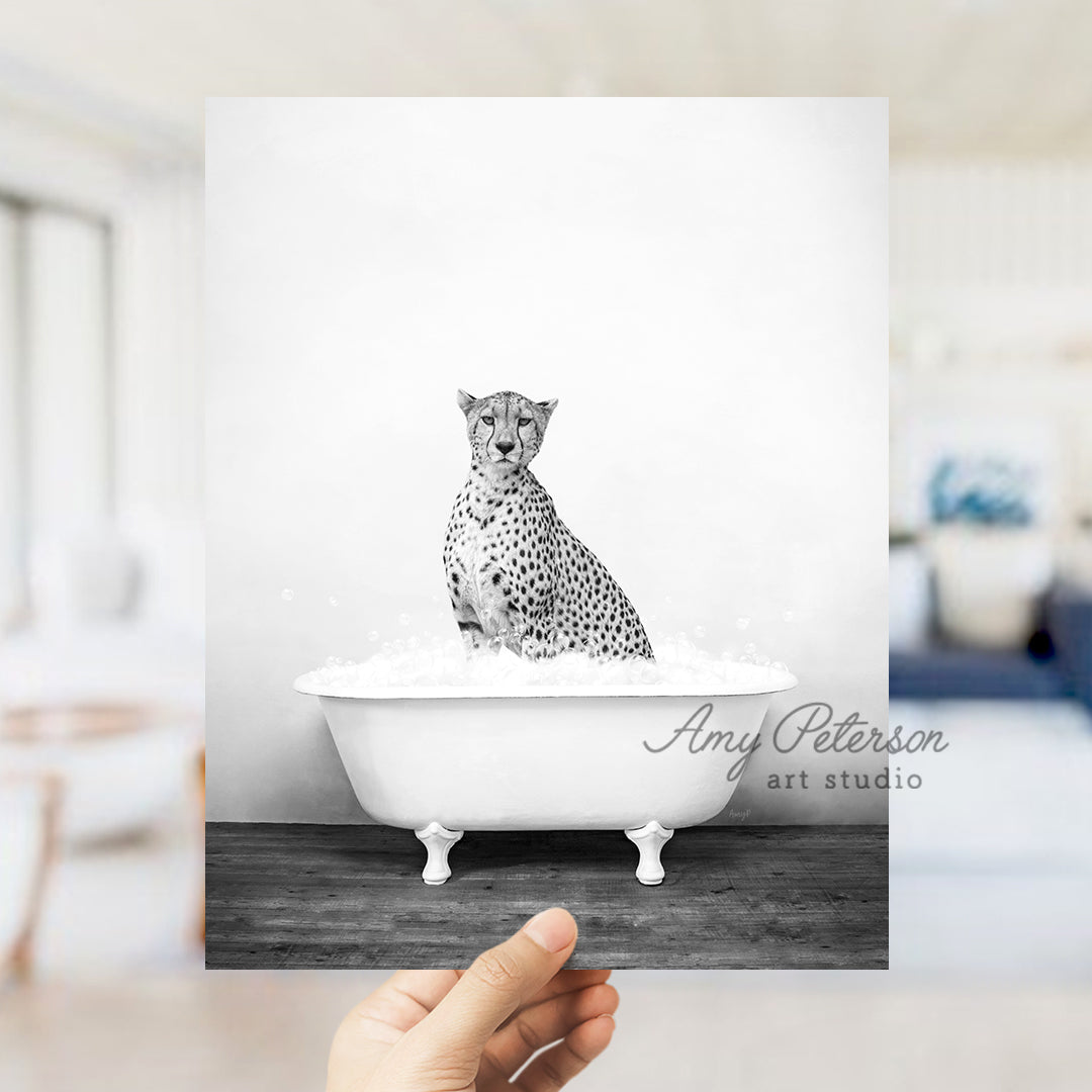 a black and white photo of a cheetah in a bathtub