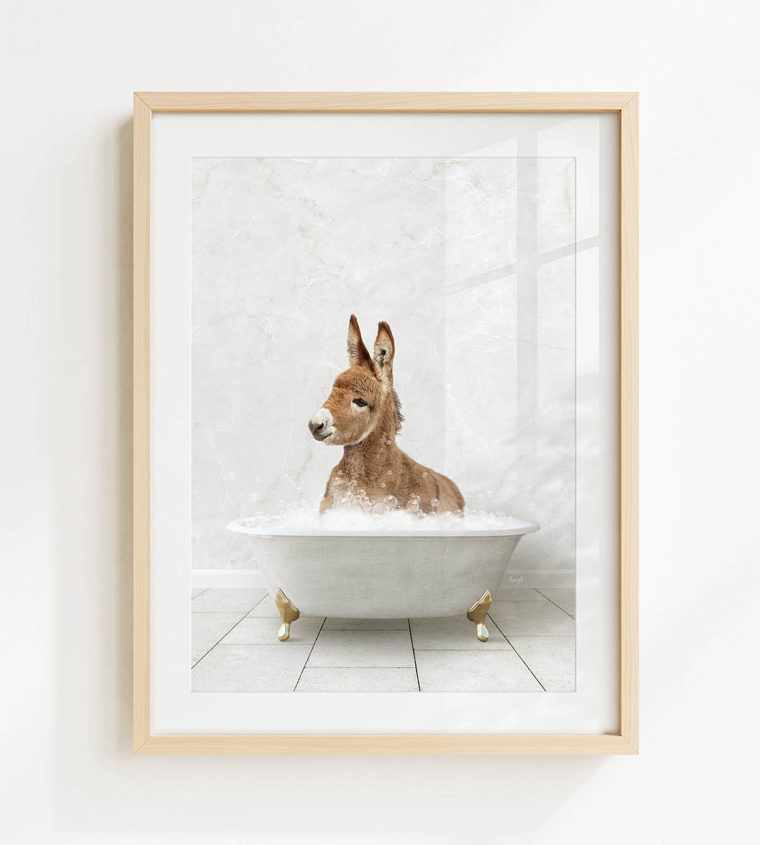 A donkey is sitting in a white bathtub filled with bubbles, looking directly at the camera.