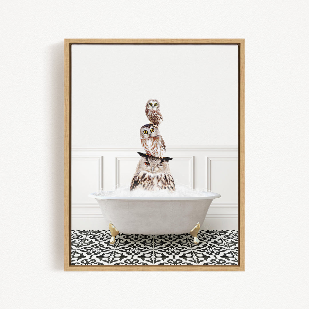 A framed image depicting three owls sitting in a white bathtub filled with water, creating a whimsical and playful scene.