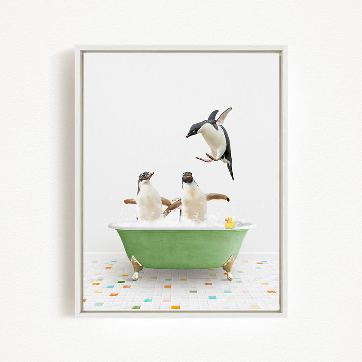 A framed image depicting two penguins sitting in a green bathtub, with one penguin jumping out of the tub and another penguin sitting in the tub.