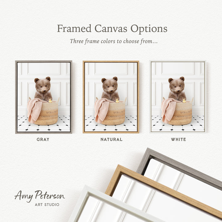 three framed canvas options, each featuring a teddy bear sitting in a basket. The options include a gray frame, a natural frame, and a white frame. The text above the images reads " Framed Canvas Options" and "Three frame colors to choose from...". The bottom of the image includes the text " Amy Peterson ART STUDIO".