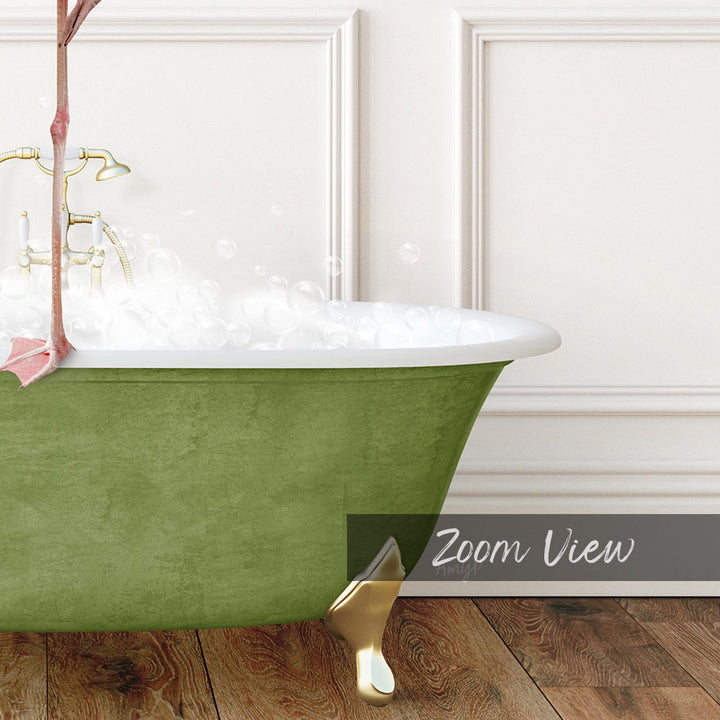 A green claw-foot bathtub filled with bubbles, with a gold claw-foot bathtub stand placed on a wooden floor.