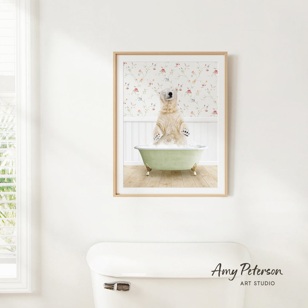 A framed image of a polar bear sitting in a bathtub, with a floral pattern on the wall behind it.