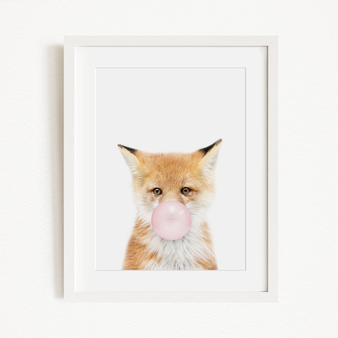 A framed image of a fox blowing a bubble with a pink bubble gum bubble.