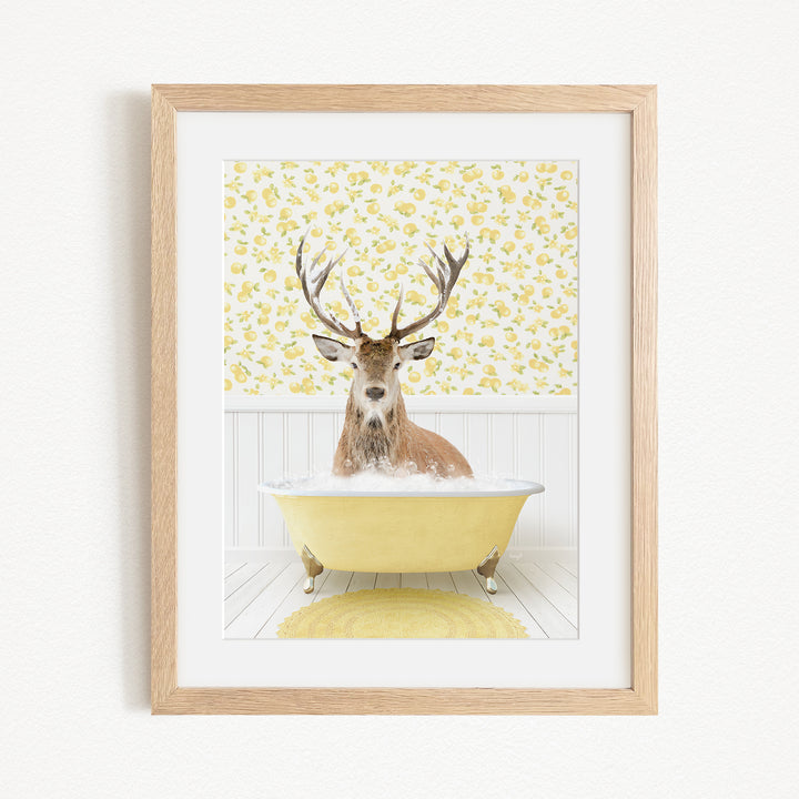 A deer with antlers is sitting in a yellow bathtub, surrounded by a yellow floral pattern on the wall behind it.