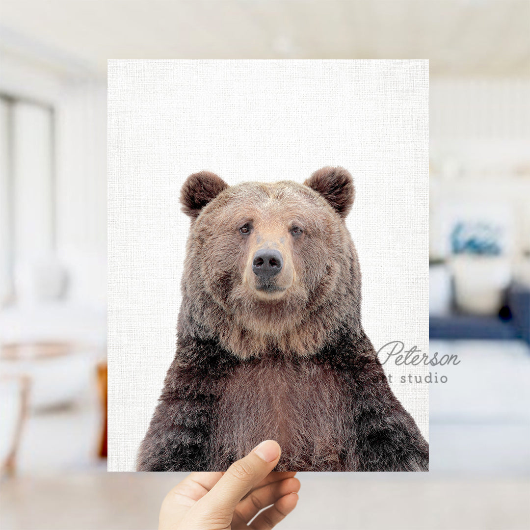 a person holding up a picture of a bear