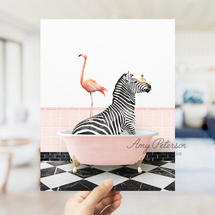 a person holding up a card with a zebra and a flamingo in a bath