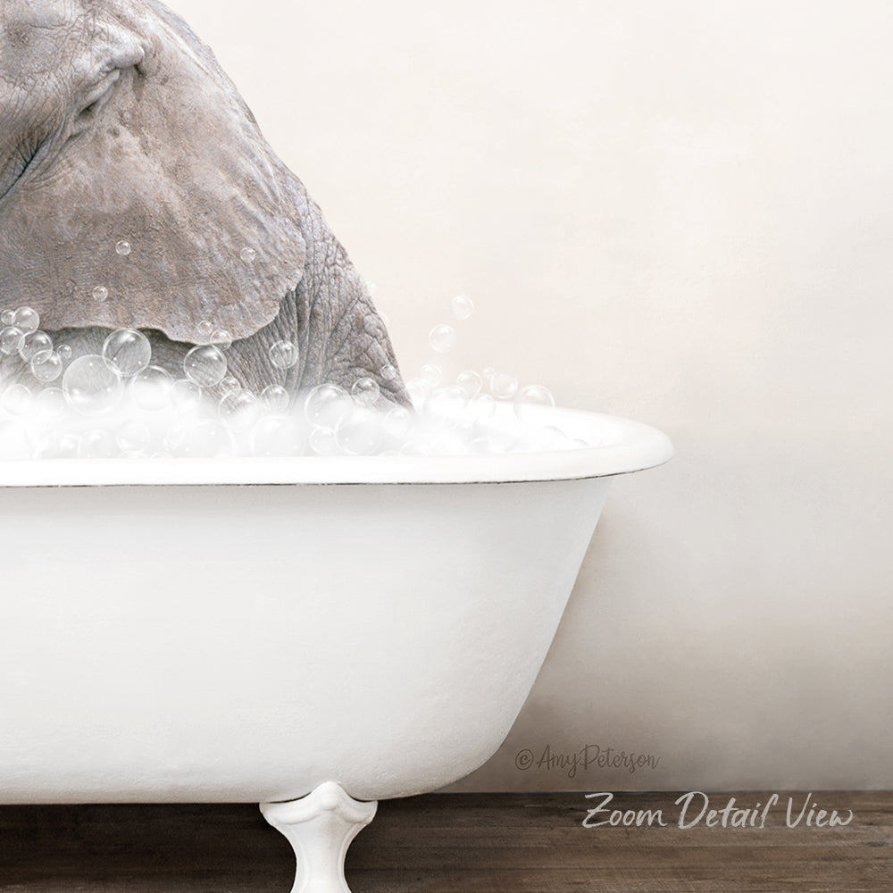 A gray elephant is taking a bath in a white bathtub, surrounded by bubbles.