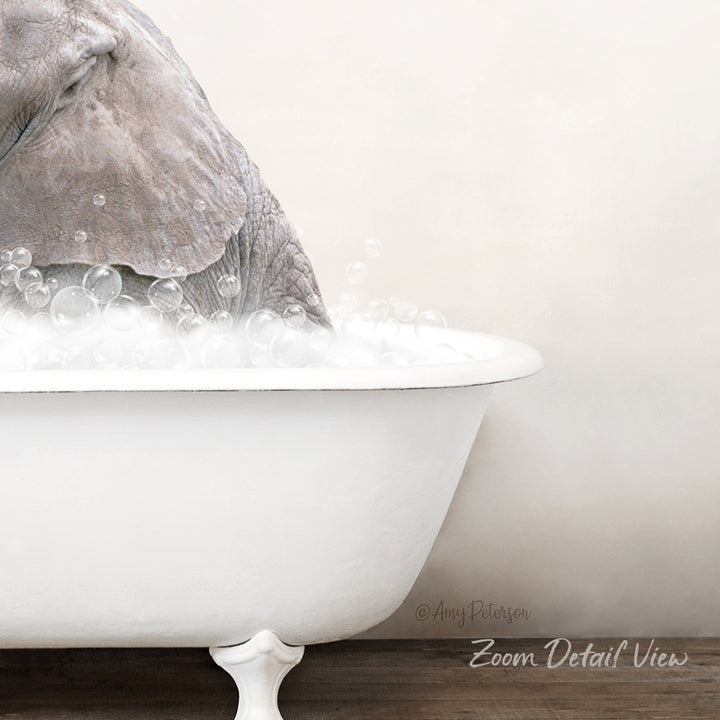 A gray elephant is taking a bath in a white bathtub, surrounded by bubbles.