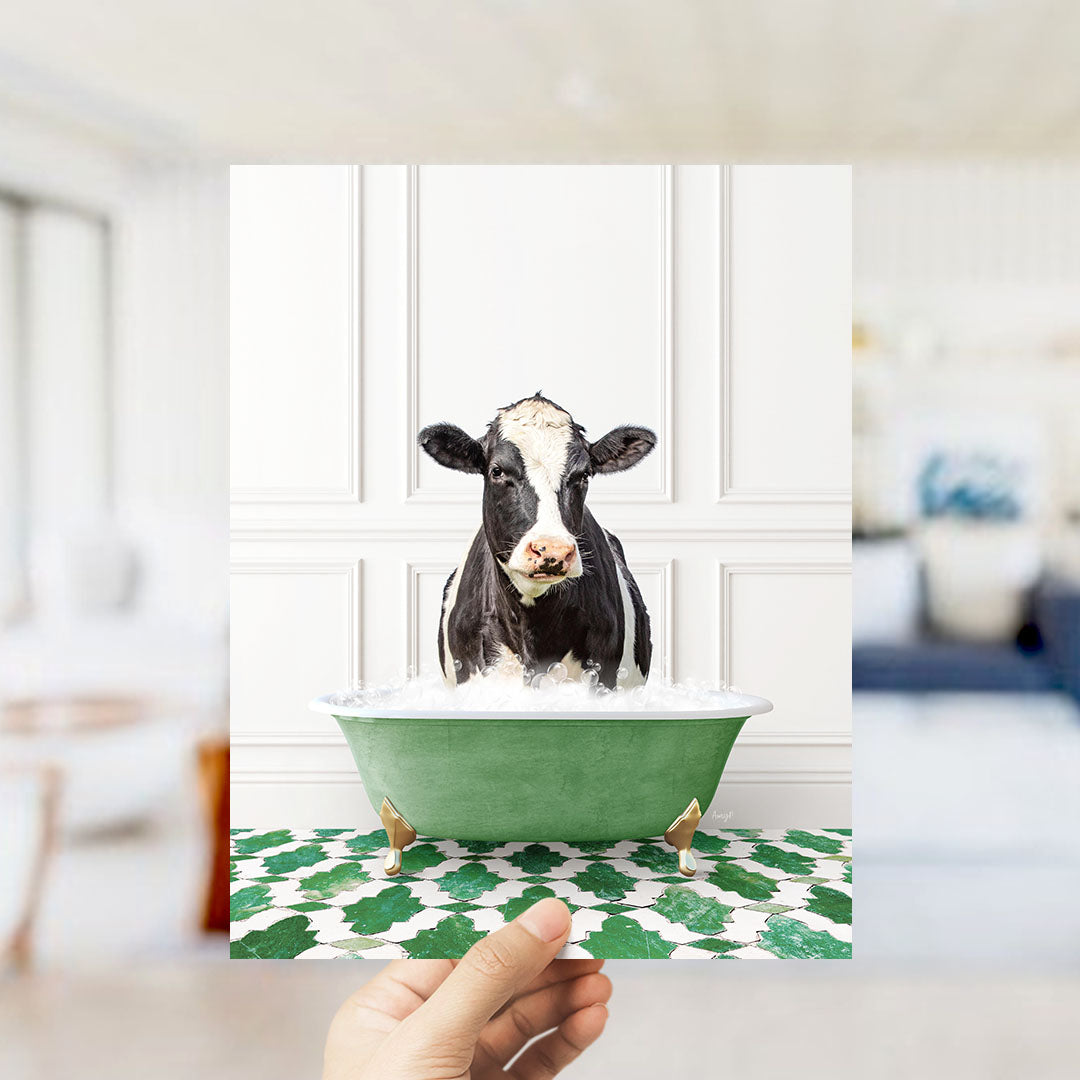A black and white cow is sitting in a green bathtub filled with water, surrounded by a patterned green and white floor.