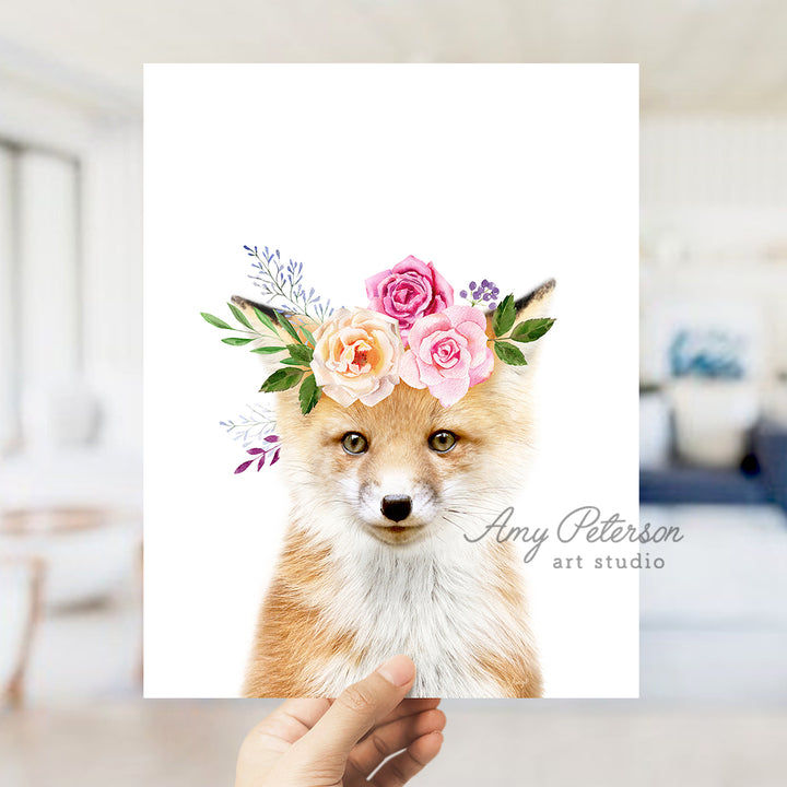 a hand holding up a card with a picture of a fox wearing a flower crown