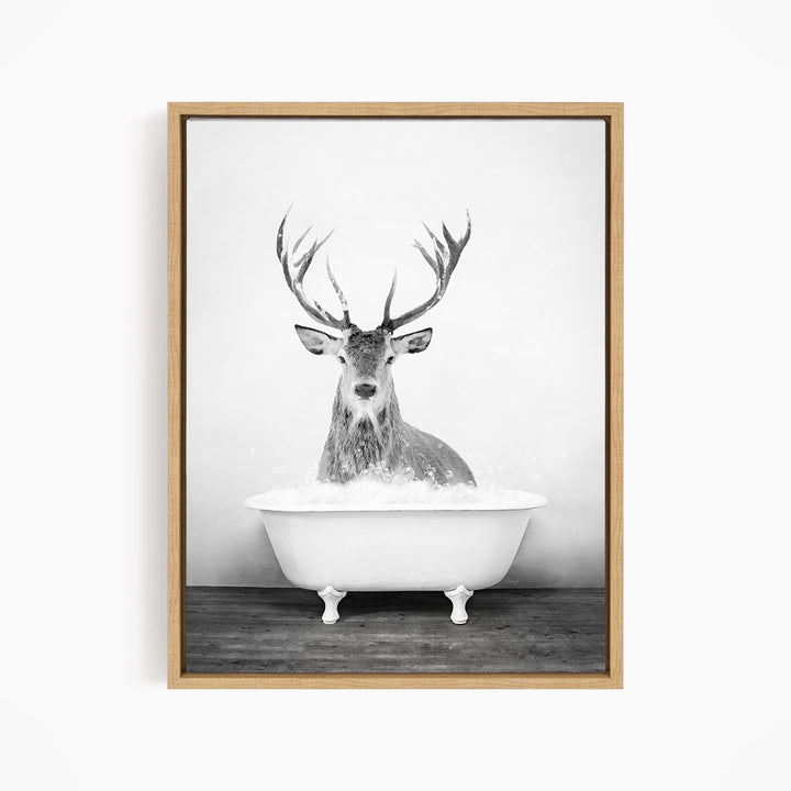A deer with large antlers is sitting in a bathtub filled with water, creating a whimsical and unexpected scene.