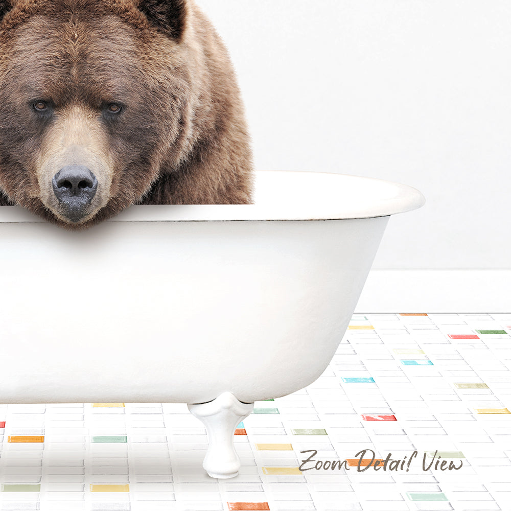A large brown bear is sitting in a white bathtub, looking directly at the camera.