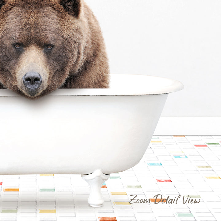 A large brown bear is sitting in a white bathtub, looking directly at the camera.