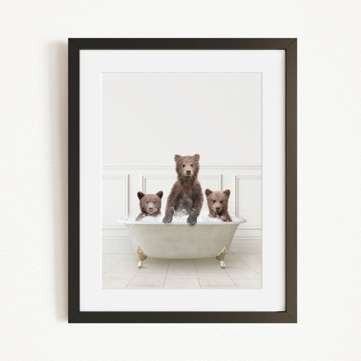 A framed image of three bears sitting in a bathtub, with one bear sitting in the center and the other two bears sitting on either side.