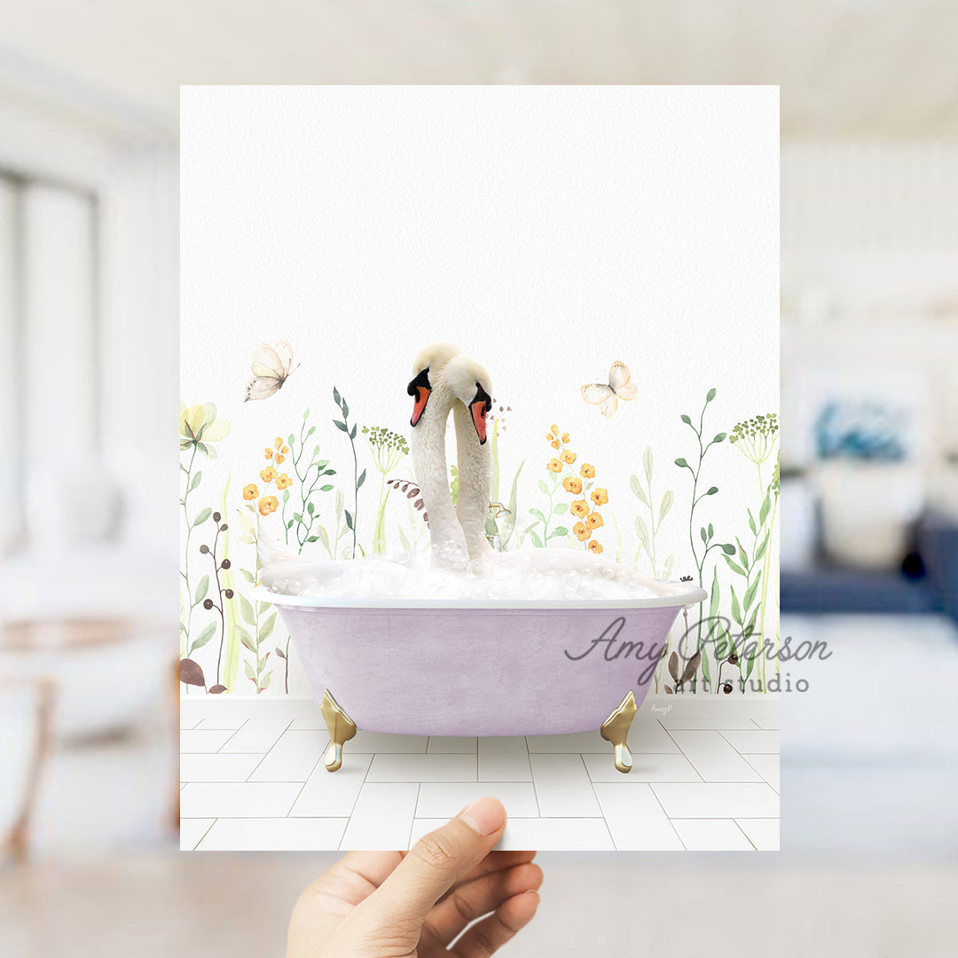 a person holding a card with two swans in a bathtub