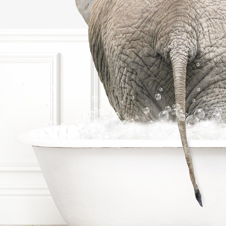 an elephant taking a bath in a bathtub