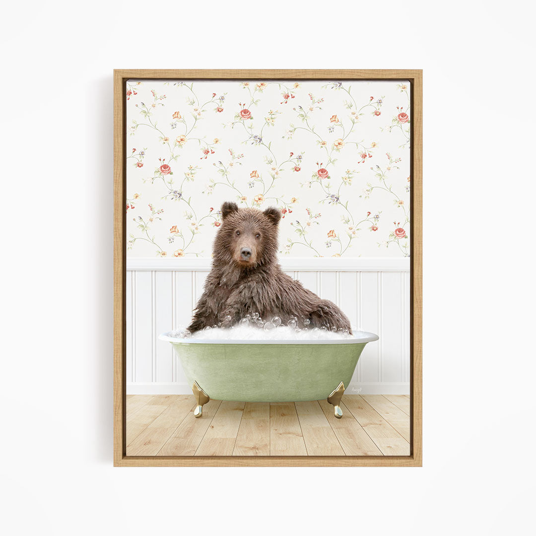 A brown bear sitting in a green bathtub filled with water, with a floral wallpaper in the background.