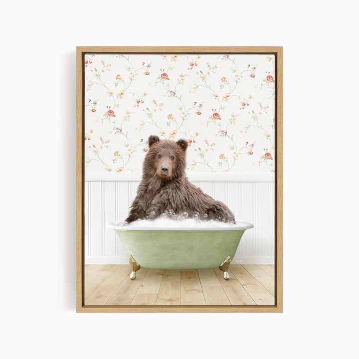 A brown bear sitting in a green bathtub filled with water, with a floral wallpaper in the background.