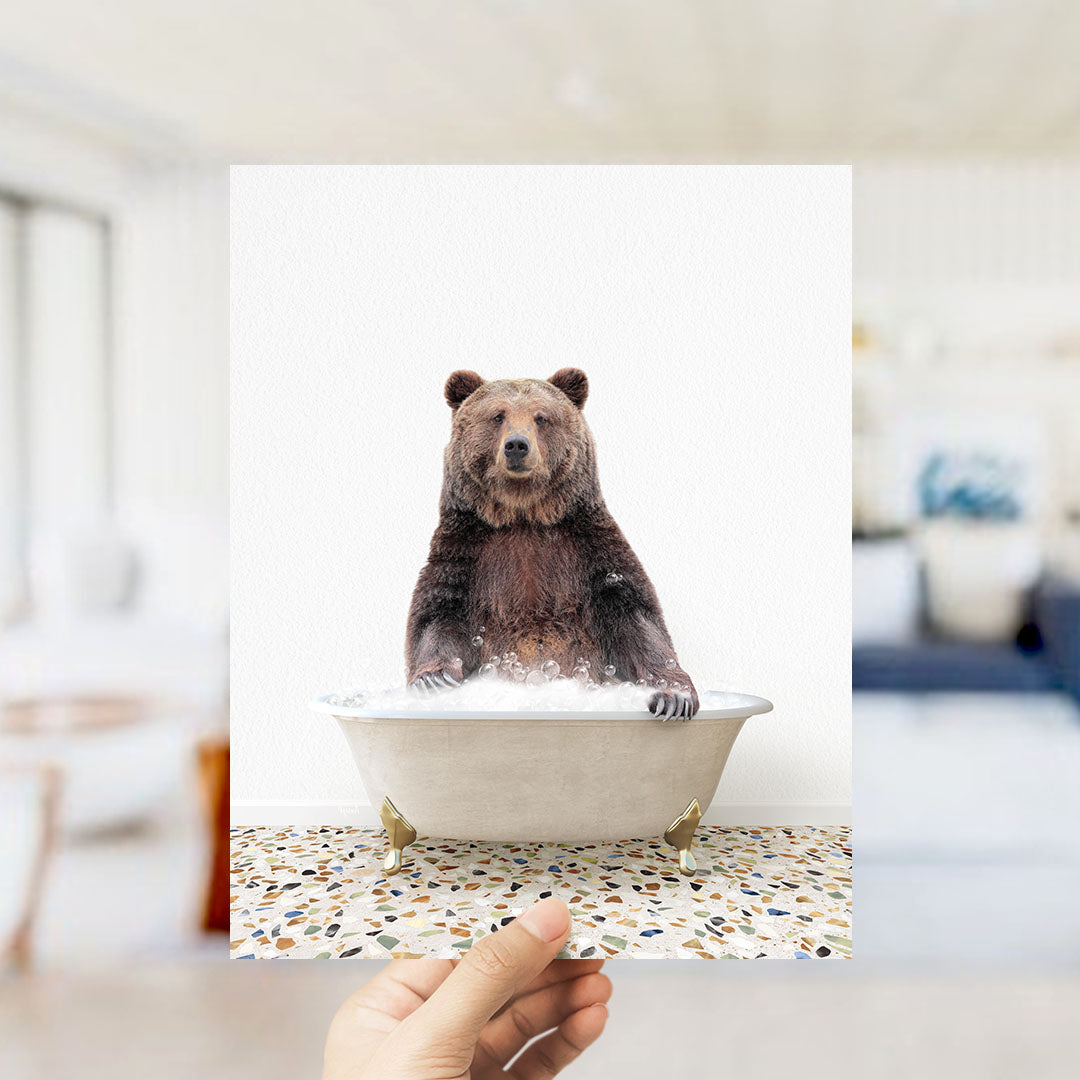 A brown bear sitting in a bathtub filled with water, appearing to be enjoying the bath.
