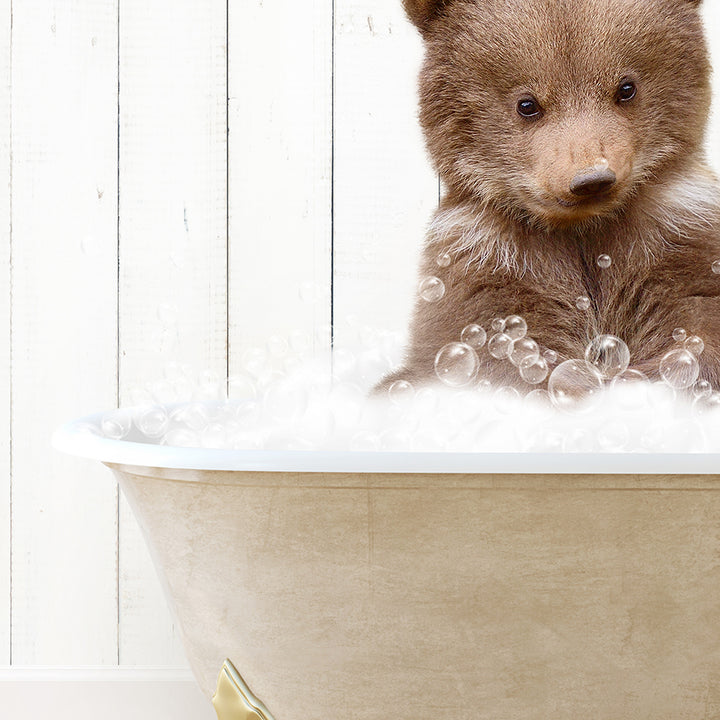 a brown bear sitting in a bath tub filled with bubbles