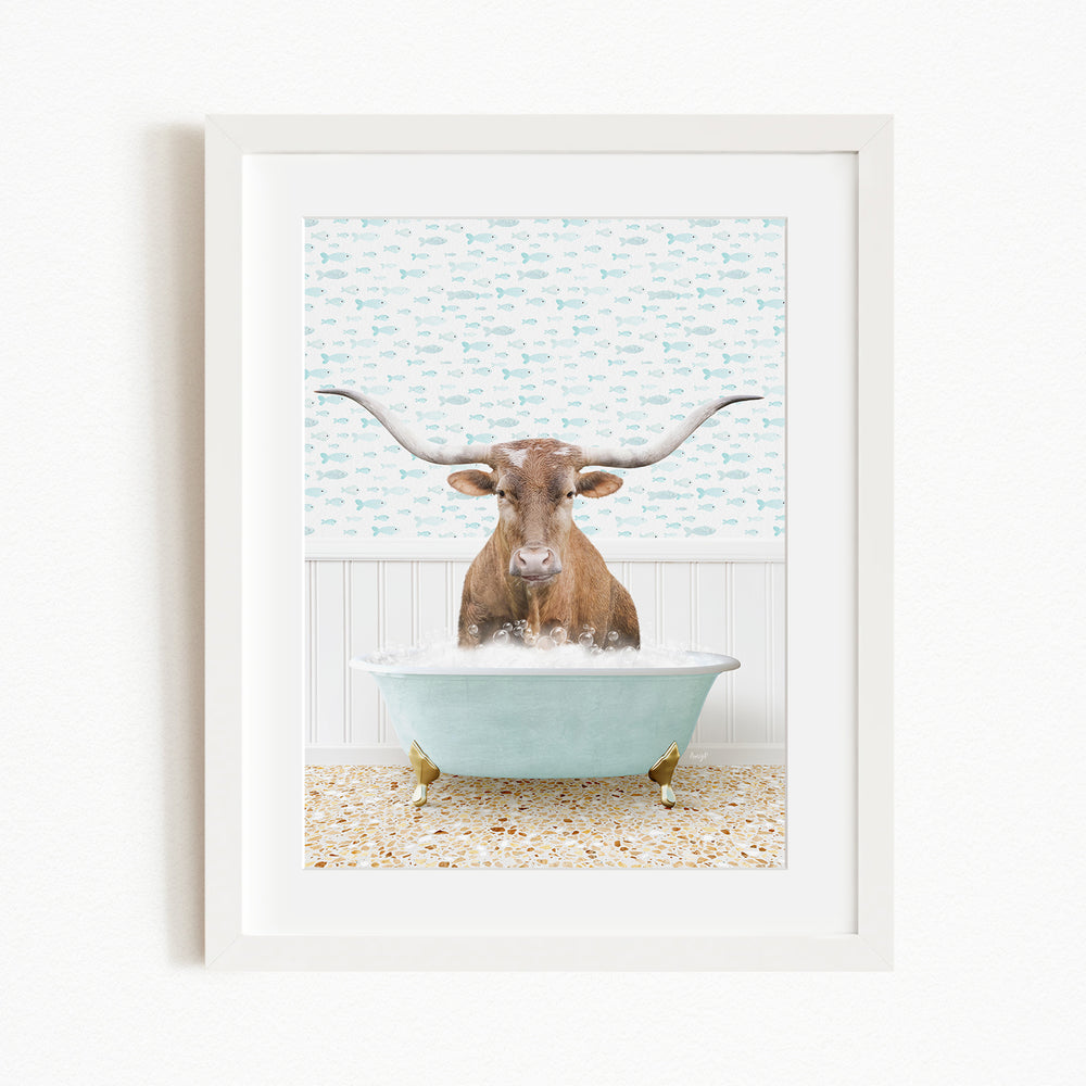 A brown cow with large horns is sitting in a light blue bathtub filled with bubbles, creating a whimsical and playful scene.