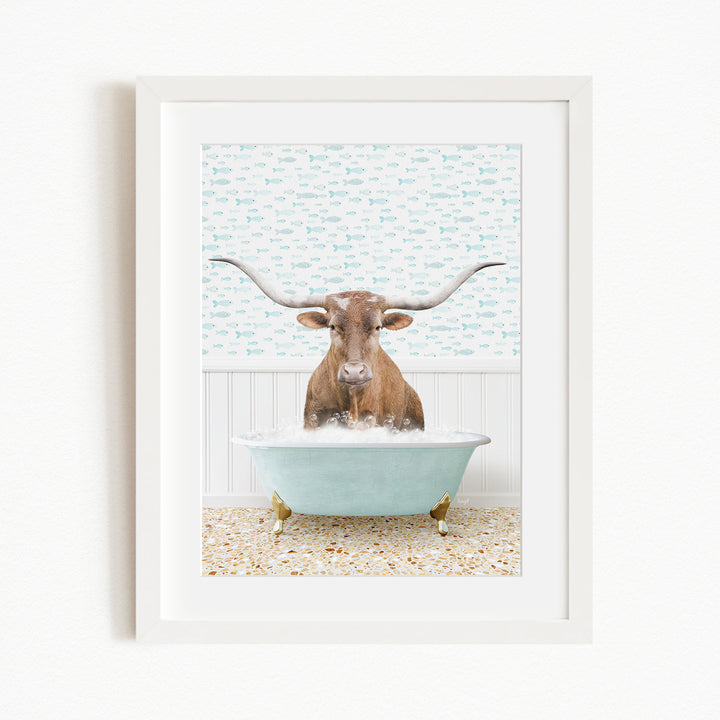 A brown cow with large horns is sitting in a light blue bathtub filled with bubbles, creating a whimsical and playful scene.