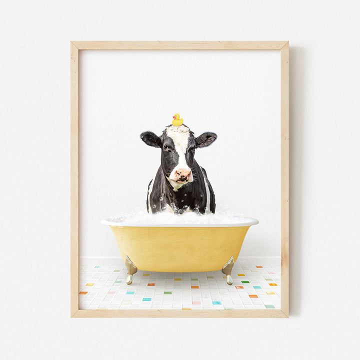 a black and white cow sitting in a bathtub