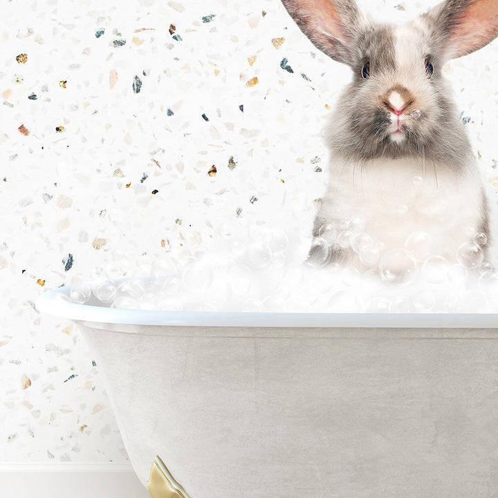 a rabbit is sitting in a bathtub with bubbles