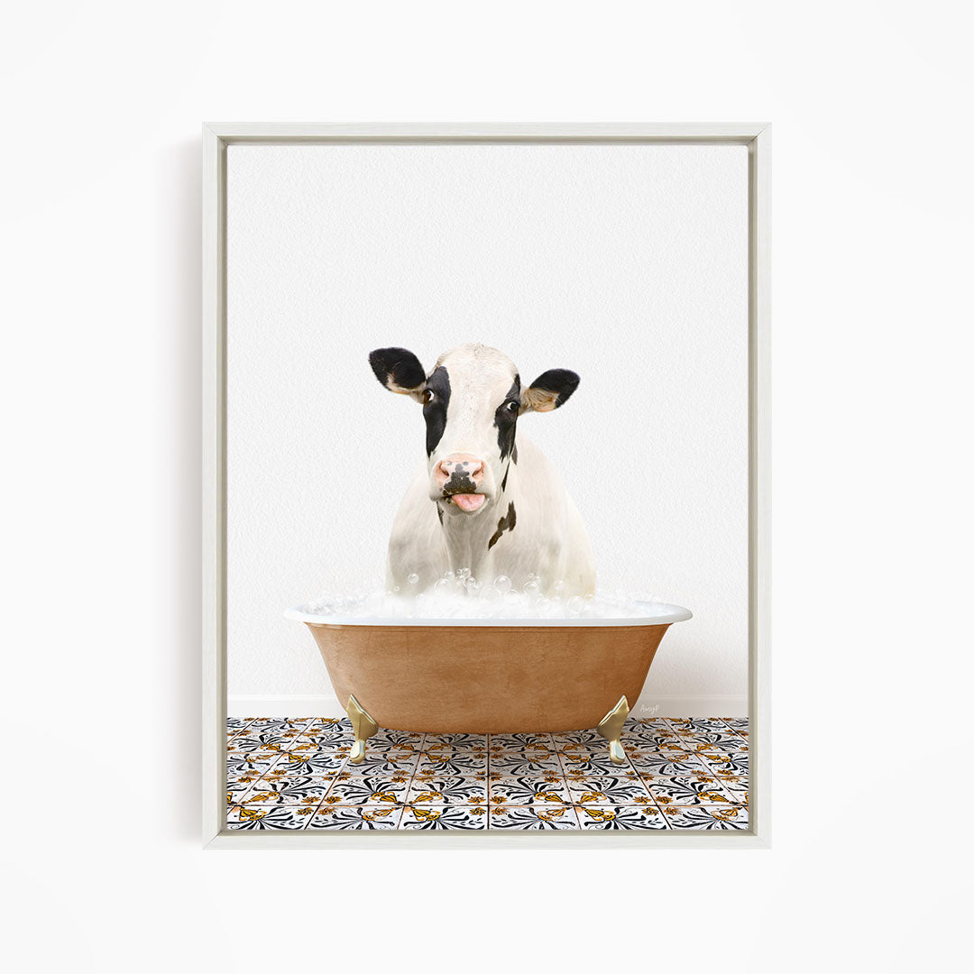 A black and white cow is sitting in a bathtub filled with water, creating a whimsical and humorous scene.