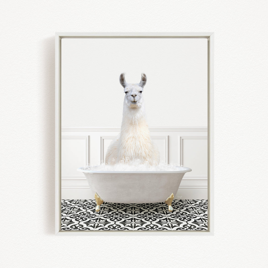 A white llama sitting in a white bathtub filled with bubbles, surrounded by a black and white patterned floor.