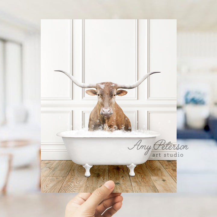 a person holding up a photo of a cow in a bathtub