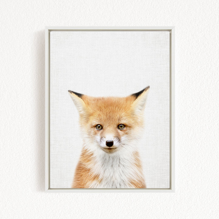 A framed print of a young fox with a friendly expression, looking directly at the camera.
