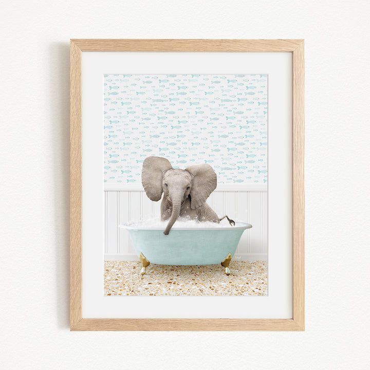 A baby elephant sitting in a blue bathtub filled with water, surrounded by a patterned wall and a wooden floor.
