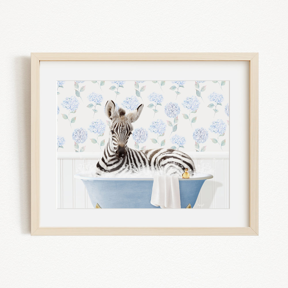 A zebra is sitting in a blue bathtub filled with water, surrounded by a floral pattern on the wall behind it.