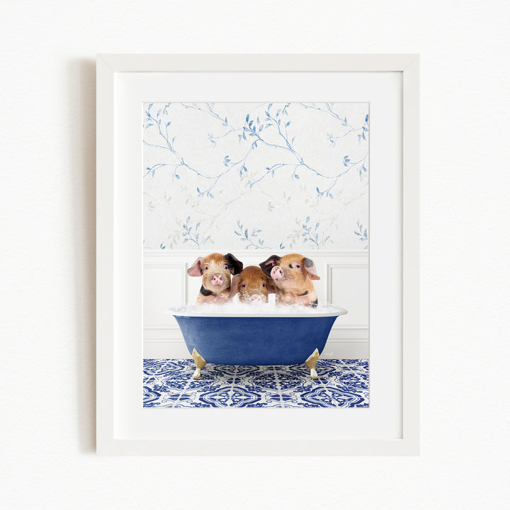 Three adorable pigs sitting in a blue bathtub, with a floral patterned wall behind them.