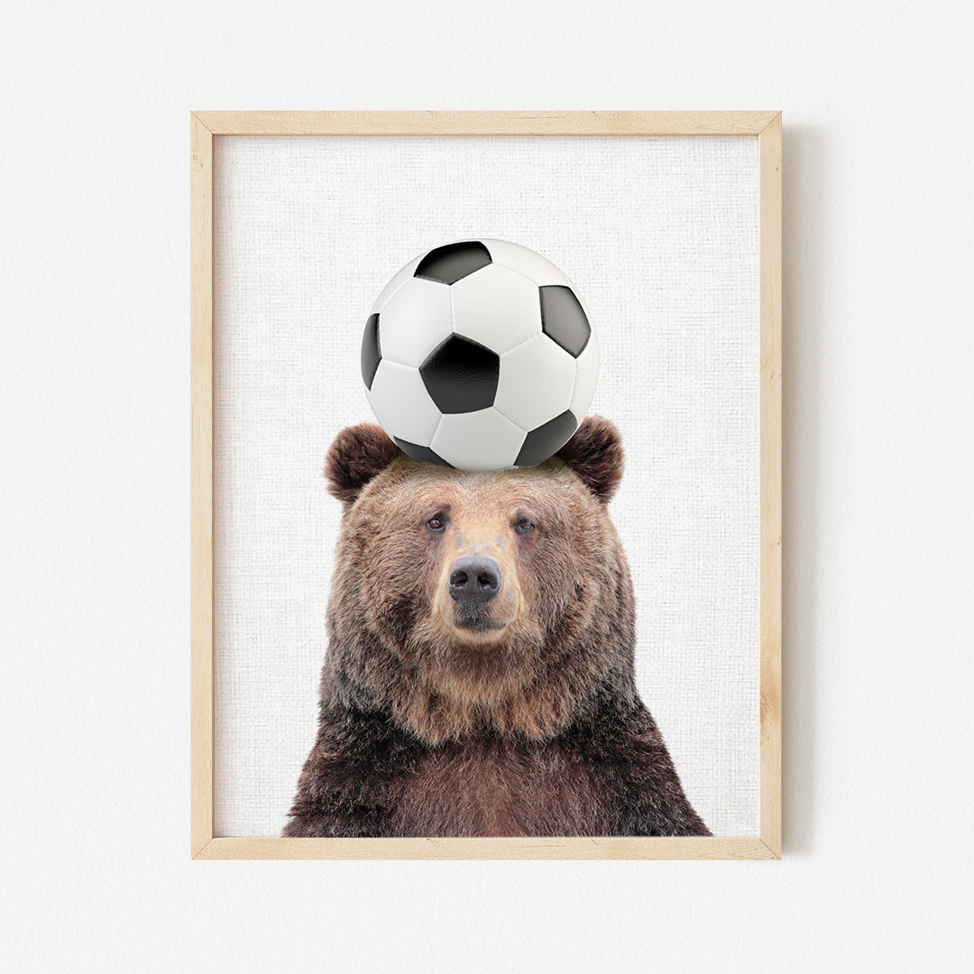 a picture of a bear with a soccer ball on its head