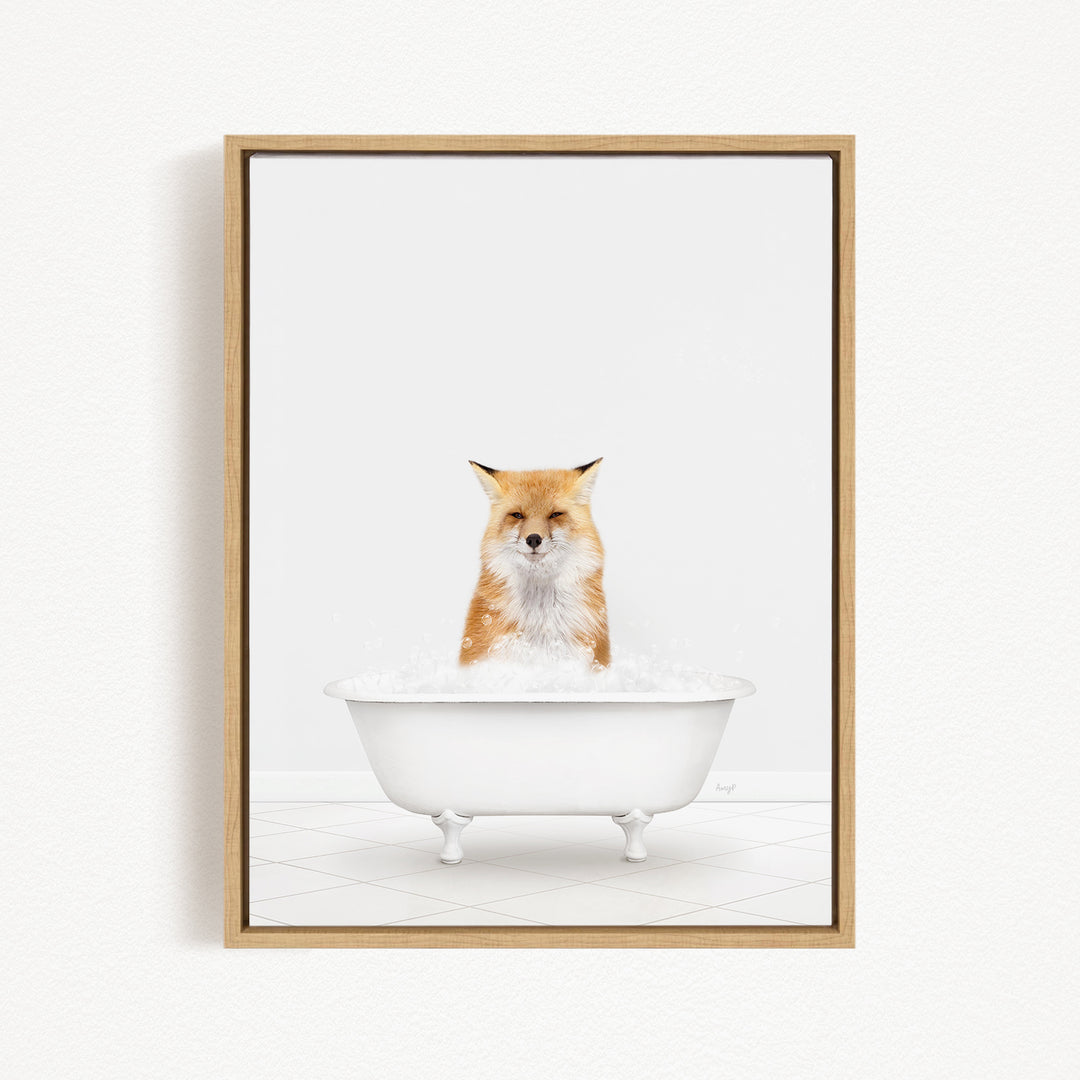 A red fox sitting in a white bathtub filled with bubbles.