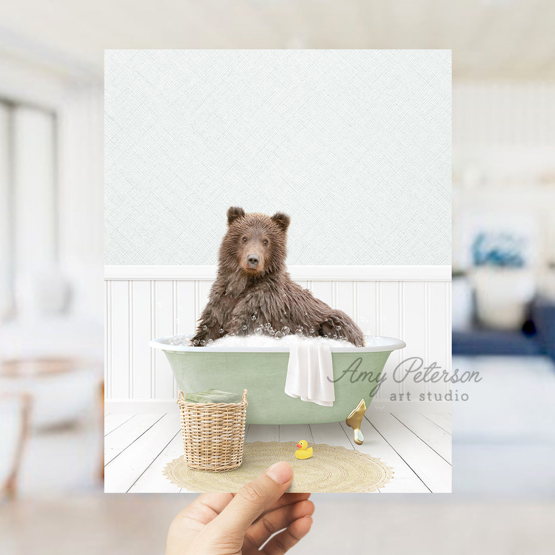 a person holding up a card with a bear in a bathtub